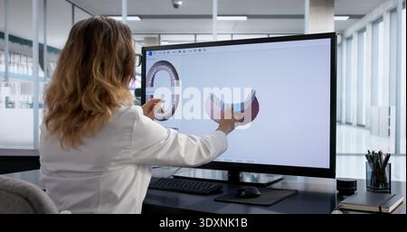 Female Dentist Using 3D Imaging Technology In Medical Examination Stock Photo
