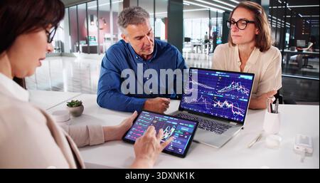 Proficient Stock Exchange Analyst Reviewing Market Trends With Senior Broker Stock Photo