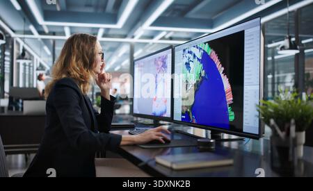 Meteorologist Woman Analyzing Weather Data On Multiple Screens, Tracking Hurricane. Stock Photo