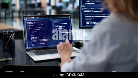 Female Engineer Creating Secure Software Code On Laptop Screen Stock Photo