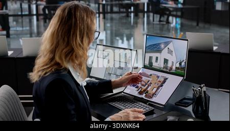 Female Real Estate Agent Using CAD Software For Interior Design Stock Photo