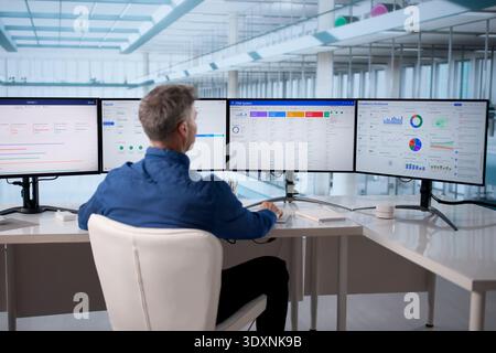 Corporate Manager Using Business Software System To Monitor Sales Process Stock Photo