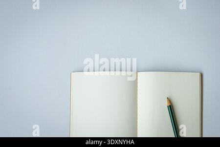 Open notepad with one pencil. Top view. Space for text. Stock Photo