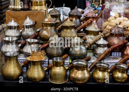 A collection of new,small, metal pots with wood handles called a cezve in Turkish or an ibrik in Arabic which are used for brewing Turkish coffee. Stock Photo
