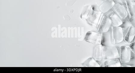 Melting ice cubes in a splash of water on a white background Stock Photo