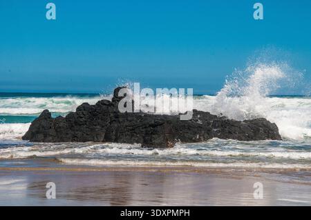 Waves breaking over an outcrop on Berrys Beach on Phillip Island, Victoria, Australia Stock Photo