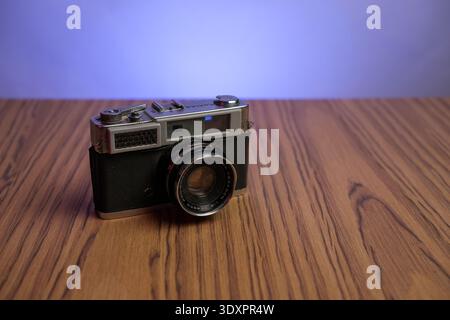 Basra, Iraq- March 03, 2026: Vintage Konica Rangefinder Camera with Hexanon Lens on Wooden Surface Stock Photo