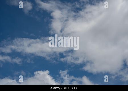 Widespread hazy white clouds partially covering a blue sky Stock Photo