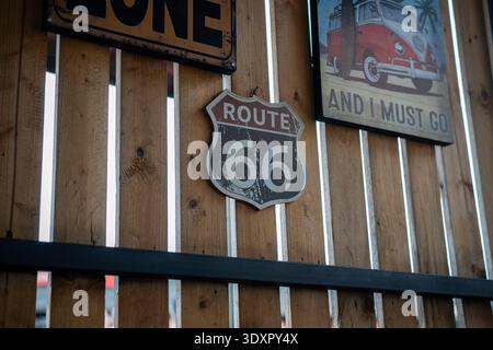 Route 66 shield sign and vintage camper van art on wooden slat wall Stock Photo
