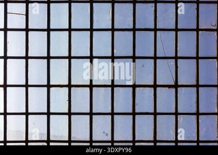 Smooth glass square blocks wall texture with cement joints. Squared glass block wall structure. Textured glass backdrop. Retro grungy style building c Stock Photo