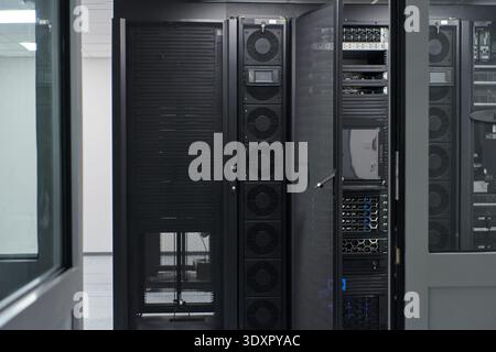 Modern data center with server racks and network equipment inside a secure IT room for enterprise infrastructure Stock Photo