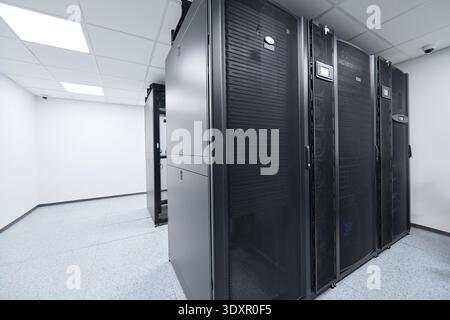 Modern data center server racks in a clean, climate-controlled server room for enterprise IT infrastructure Stock Photo