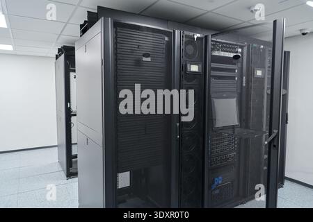 Modern data center server racks and network equipment inside a secure IT server room with cooling systems Stock Photo