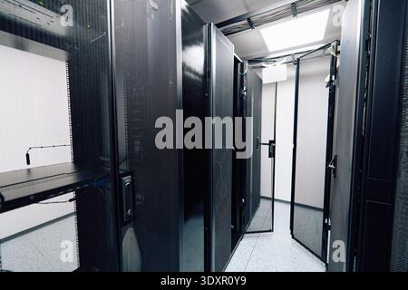 Empty server room aisle with open racks and network equipment in a modern data center Stock Photo