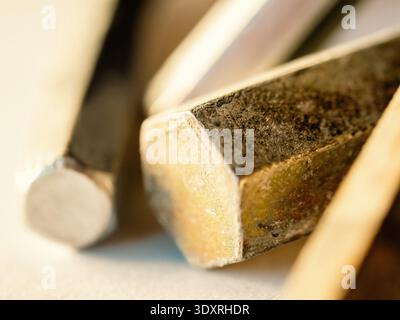Close-up of worn metal tools resting together. Surface shows rust and scratches from heavy use. Tools appear sturdy, practical, and well-loved. Implie Stock Photo