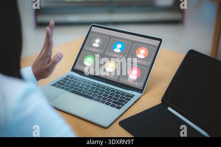 Video conference online meeting laptop business working woman home office webinar. Remote work concept with female hand waving to colleagues on virtua Stock Photo