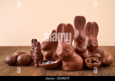 Chocolate bunnies and easter eggs on wood surface Stock Photo