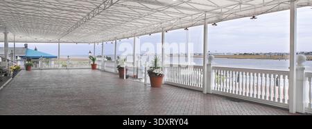 Very large restaurant patio seating area looking out over the water, Delaware USA Stock Photo