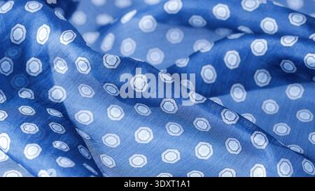Abstract blue natural silk background. Silk fabric with polka dots pattern closeup. Stock Photo