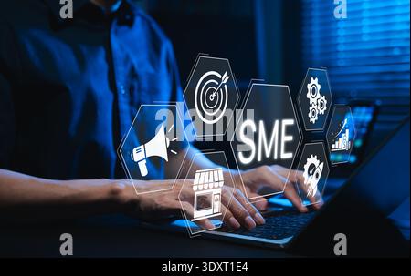 Small and medium enterprise concept. small business management, Businessman using laptop with icons for SME, marketing, target, retail, and growth Stock Photo