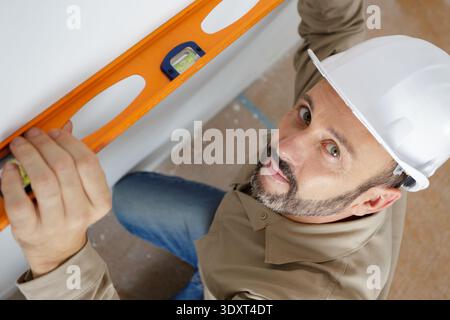 high angle view of tradesman using a spirit level Stock Photo