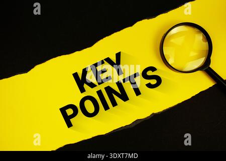 Key Points text on yellow with black paper torn ripped and magnifying glass Stock Photo