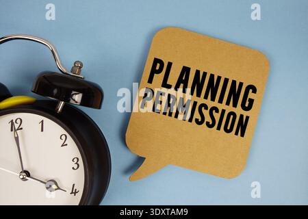 Planning Permission text with alarm clock on blue background Stock Photo