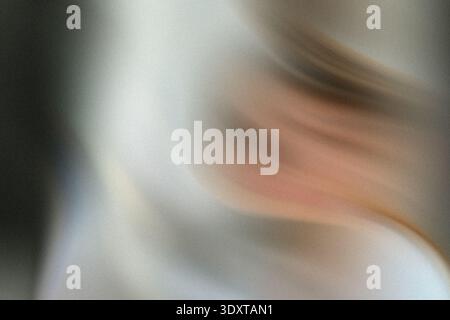 A blurry close up shot of a person with fair skin and light hair near a dark colored background element Stock Photo