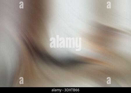 A blurry close up shot of a hand holding a black object against a white background in soft lighting Stock Photo