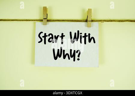 Start With Why paper notes hanging on the rope with clothespins Stock Photo