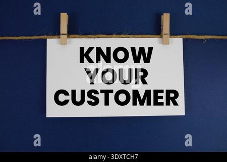 Know Your Customer (KYC) text written on paper card with rope and wooden clip hanging Stock Photo