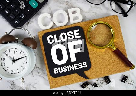 COB - Close Of Business acronym with calculator, alarm clock and magnifying glass, Business concept background Stock Photo