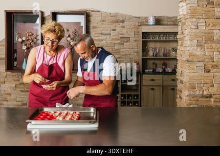 Chefs preparing appetizers during cooking course in restaurant kitchen Stock Photo