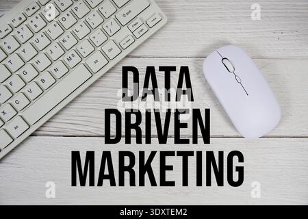 Data Driven Marketing text with keyboard and wireless mouse on wooden background Stock Photo