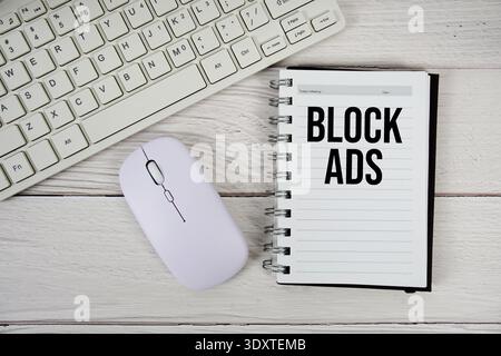 Block Ads text with keyboard and wireless mouse on wooden background Stock Photo