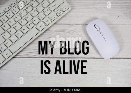 My Blog is Alive text with keyboard and wireless mouse on wooden background Stock Photo