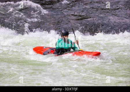 Robbinsville, North Carolina, USA - October 18, 2025: Close up of a kyakers in a red kyak in the white waters of the Cheoah River. Stock Photo