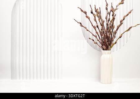 Delicate willow branches in vase on kitchen table. Palm Sunday concept, preparation for Easter celebrations, design template with space for text and a Stock Photo