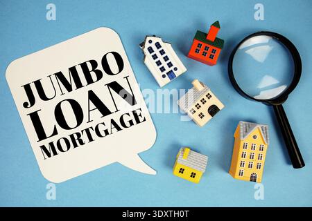 Jumbo Loan Mortgage text with house models on blue background Stock Photo