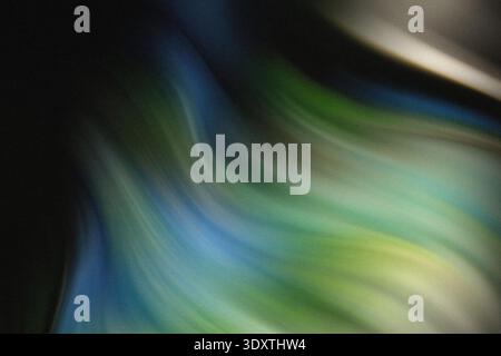 A blurry abstract image featuring shades of blue green and dark colors creating a soft and dreamy effect Stock Photo