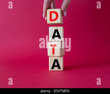 Data symbol. Concept word Data on wooden cubes. Businessman hand. Beautiful red background. Business and Data concept. Copy space. Stock Photo