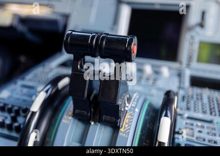 Close-up view of engine throttle levers inside commercial airplane cockpit. Aviation control, flight operation, pilot workspace, technology, and trans Stock Photo