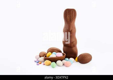 Chocolate easter bunny with decorated candy eggs Stock Photo