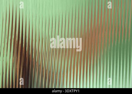 A blurry abstract image featuring shades of green and brown with indistinct shapes and soft lighting Stock Photo