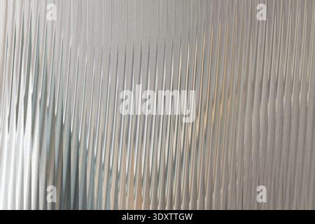 A blurry abstract image showing a mix of white gray and some green tones in a soft diffused manner Stock Photo