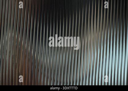 A blurry and dark abstract image featuring shades of gray and white with hints of green and blue light Stock Photo