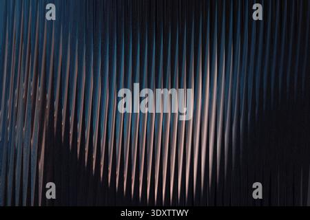 Abstract dark image featuring a blurry light area against a darkened background with blue hues visible Stock Photo
