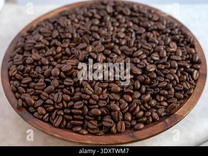 A detailed high-angle macro shot of high-quality roasted coffee beans. The frame is filled with rich brown beans, showcasing their oily sheen and uniq Stock Photo