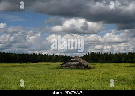 Landscape with a cabin in Lapland, Finland. Typical Finnish landscape with a wood cabin in forest Stock Photo