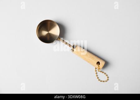 Golden scoop on light background, top view Stock Photo